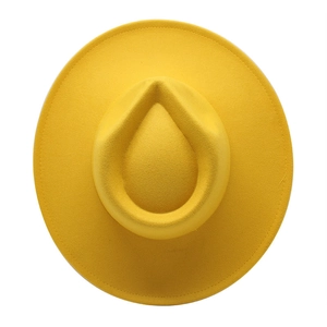 Top down view of a vibrant yellow felt fedora hat with a classic teardrop crown shape