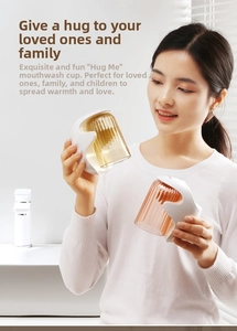 Detail of creative hug-shaped magnetic cup holder with amber textured rinsing glass