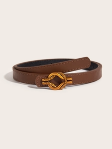 Close-up of brown leather belt featuring a unique gold knotted metal buckle on beige background