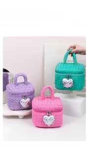 Three quilted makeup bags in pink, purple, and green with silver heart charms and bows