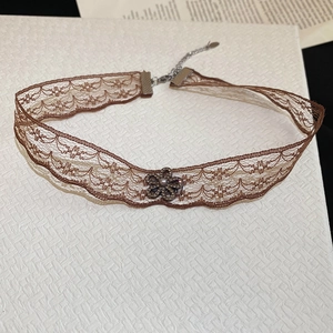 Detail of vintage brown lace choker with floral pendant and adjustable lobster clasp