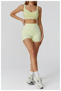 Front view of light yellow high-waist sports bra and yoga shorts set on model