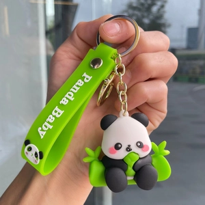 Close-up of panda keychain with green 'Panda Baby' strap and gold-tone metal ring