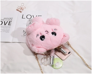 Pink plush cat shoulder bag with golden chain showing interior storage for phone and lipstick