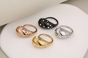 Polished teardrop rings set in gold, silver, rose gold and black with crystal accents