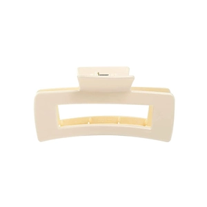 Close-up of matte cream-white rectangular hair claw clip with smooth frosted texture