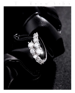 Macro shot of s925 silver wave ring with sparkling diamonds on a black background