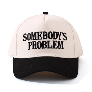 Detail of Somebody's Problem embroidery on a two-tone cotton baseball cap with black brim