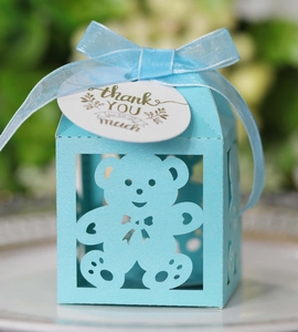 Detail of light blue hollow bear candy box with silk ribbon bow and thank you tag