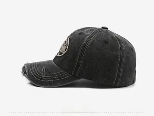 Detail of distressed brim and contrast stitching on vintage washed charcoal baseball cap