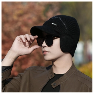 Detailed view of men's winter knit beanie with ear flaps and woven NY&JA label tag