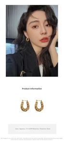 Macro view of vintage gold twisted titanium steel hoop earrings on model with product size