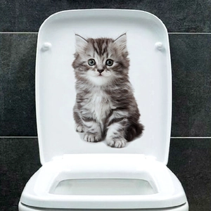 Detail of 3D realistic grey tabby cat sticker applied on a white toilet lid cover