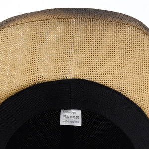 Detail view of woven paper straw cowboy hat interior with 100% paper fabric label