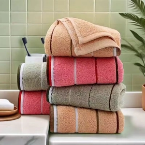 Close-up of thick absorbent cotton towels with striped texture in a bathroom setting
