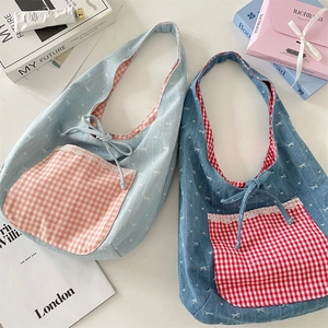 Detail showing two denim tote bags with bow patterns, lace-edged plaid pockets, and ties