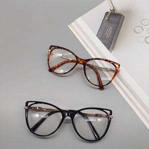 Cat eye glasses frames in tortoiseshell and black with gold metal spring legs