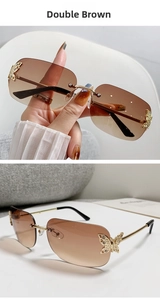 Detail of rimless square sunglasses with gradient brown lens and gold butterfly accent