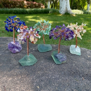 Handmade chakra crystal trees set with amethyst and quartz on raw natural stone bases