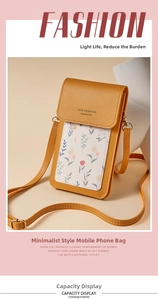 Detail of pebbled mustard yellow leather phone bag with floral pattern and gold hardware