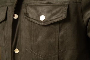 Macro shot of premium brown suede jacket featuring a golden metal button on chest pocket