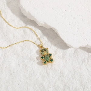 Close-up of bear pendant with green heart zircon and 14K gold plated brass chain