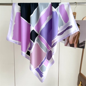 Detail of color-block twill luxury silk scarf with geometric patterns in purple and pink