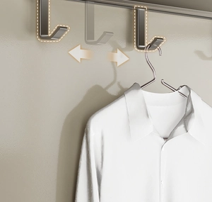 Detail of adjustable silver sliding hooks on a balcony clothes drying rack for spacing