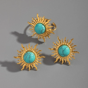 Detail of vintage sunburst turquoise jewelry set with gold finish earrings and ring