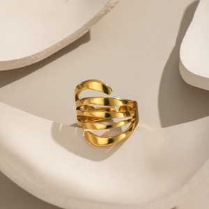 Modern multi-layer 18k gold plated stainless steel ring on a minimalist stone base