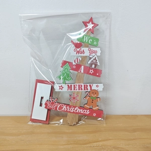 Christmas tree wooden ornament with gingerbread man and Merry Christmas text in packaging
