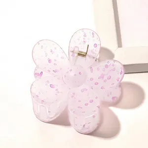 Detail of light purple flower-shaped hair claw clip with unique purple speckled pattern