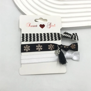 Close-up of three DIY hair bands featuring houndstooth pattern and golden snowflake pendant