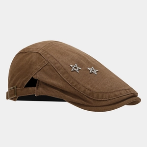 Detail of dark brown newsboy hat with silver star rivets and adjustable back strap