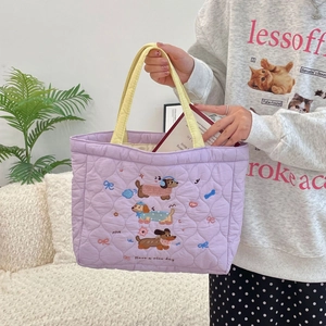 Detailed embroidery of a cute puppy with Have a nice day text on a quilted tote bag