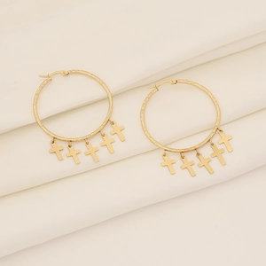 Gold stainless steel hoop earrings with five hanging cross pendants on silk background