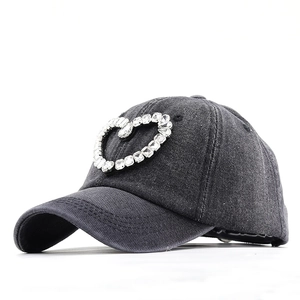Frayed denim baseball cap with crystal heart embellishment and rhinestone tassels