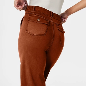 Detail of high-waist caramel wide-leg trousers showing back pocket and twill texture