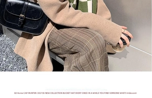 Chic green and white checkerboard knit scarf styled with a long khaki wool coat and trousers