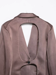 Detail of satin blazer back featuring a brown-purple fabric and oval cutout design