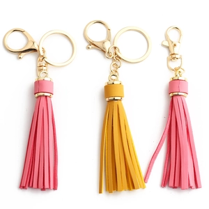 Three premium leather tassel keychains with gold lobster clasps in pink and yellow colors