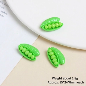 Macro shot of miniature green resin pea pods for DIY phone case crafts and accessories