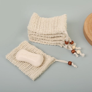 Detail of natural sisal soap foaming bags with wooden beads and drawstring closure