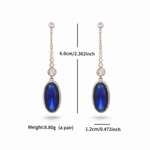 Detail of blue geometric stone earrings with rose gold frame and size specifications