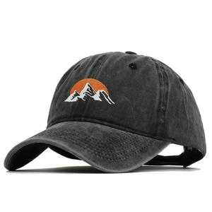 Detail of mountain embroidery on a washed black cotton baseball cap with vintage look