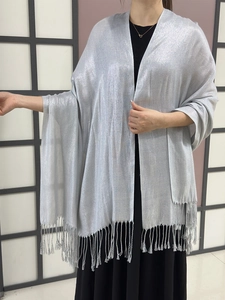 Detailed close-up of sparkling silver evening shawl featuring elegant fringe tassels