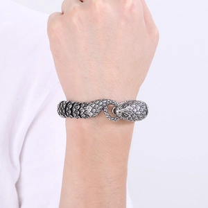 Macro detail of men's stainless steel snake link bracelet with textured silver scales