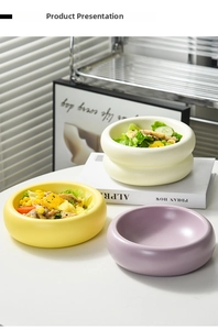 Three ceramic donut-shaped bowls in yellow, cream, and lilac holding fresh salad