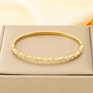 Detailed view of 18K gold plated stainless steel bangle with oval zircon inlay settings