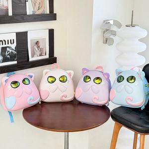 Detail view of 3D cartoon cat backpacks in pink, white, purple and blue pastel colors
